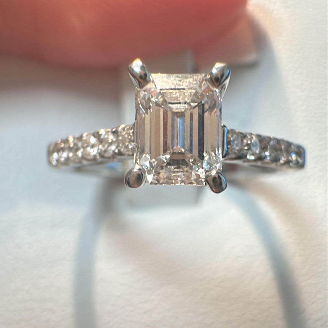 0.66 CT emerald cut lab-grown diamond ring with accent diamonds in 14K white gold.