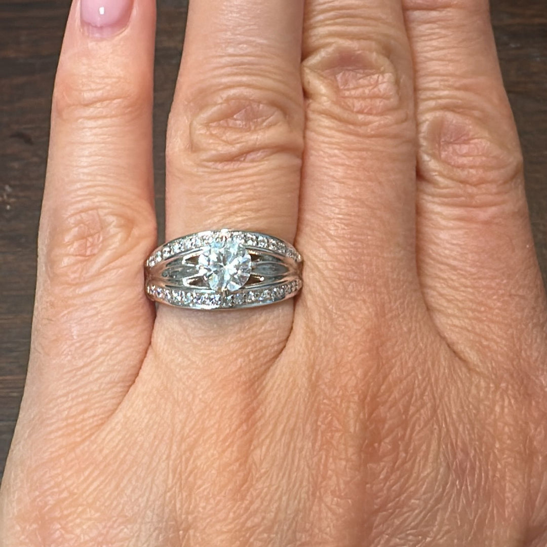 0.85 CT round moissanite engagement ring with natural diamonds in 14K white gold.