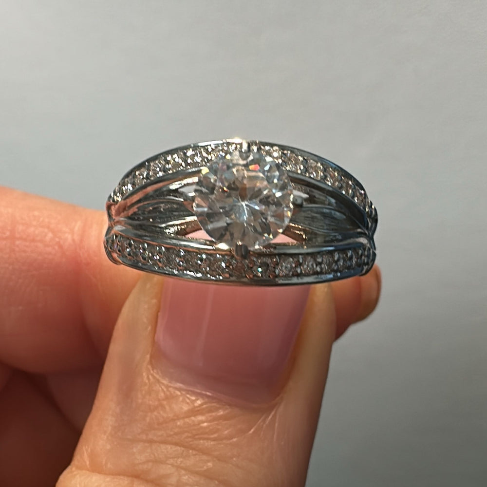 0.85 CT round moissanite engagement ring with natural diamonds in 14K white gold.
