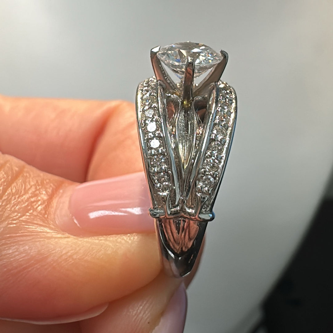 0.85 CT round moissanite engagement ring with natural diamonds in 14K white gold.
