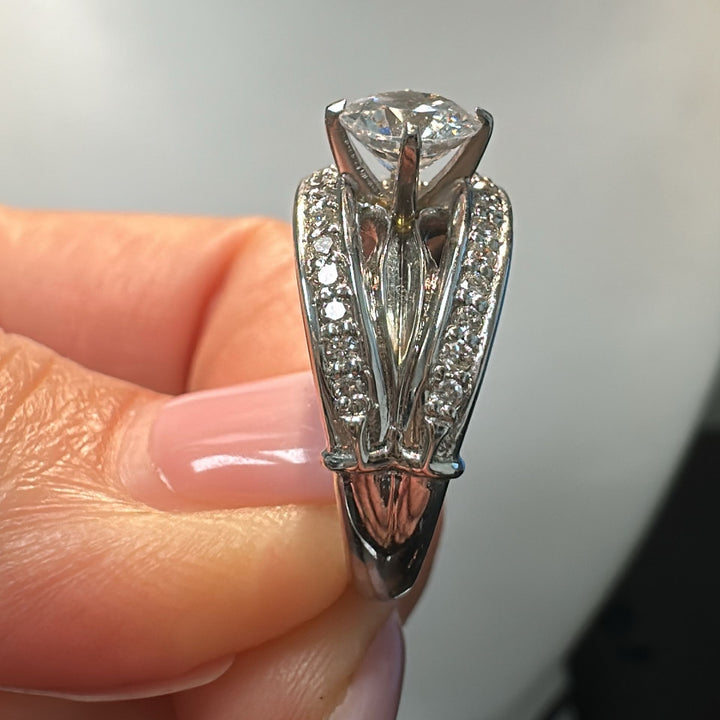 0.85 CT round moissanite engagement ring with natural diamonds in 14K white gold.