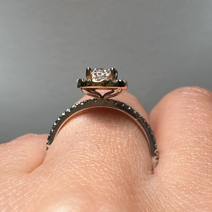 1 CT oval moissanite halo engagement ring in 14K gold with small diamonds.