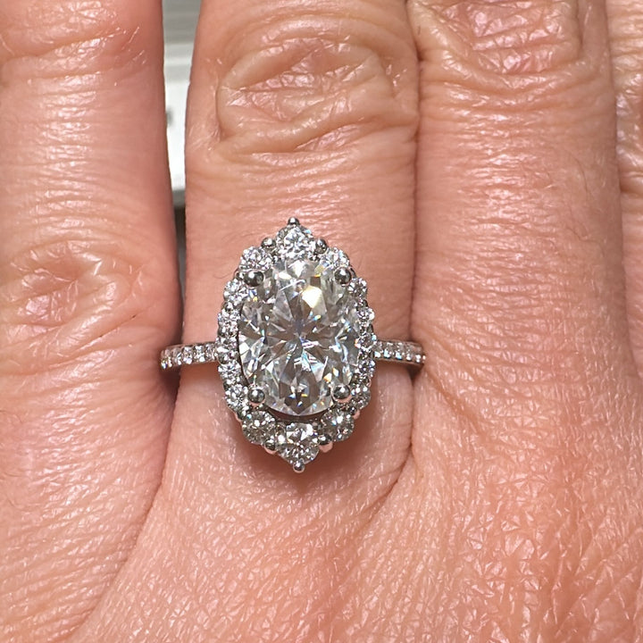 2.5 CT oval moissanite halo engagement ring in 14K gold with small moissanites.