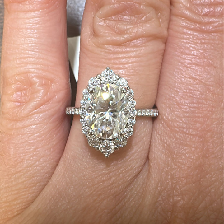 2.5 CT oval moissanite halo engagement ring in 14K gold with small moissanites.