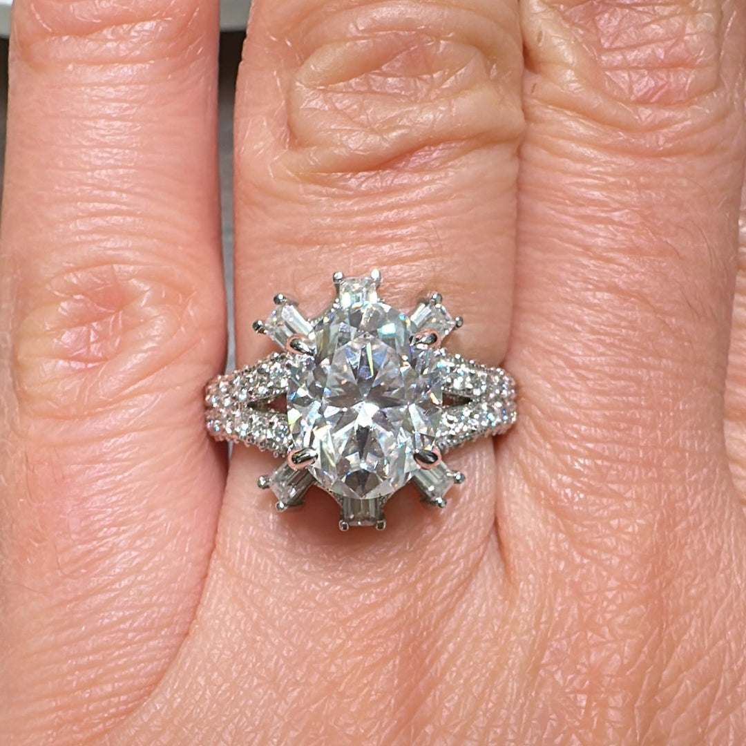 3 CT oval moissanite engagement ring in 14K gold with emerald-cut moissanites.