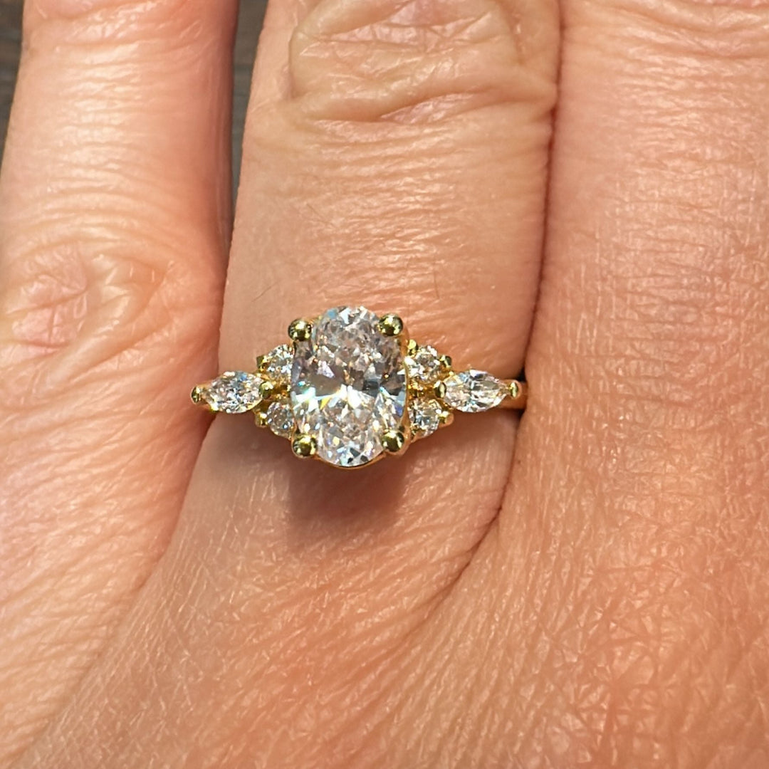 1 CT oval moissanite engagement ring in 14K gold with small moissanite accents.