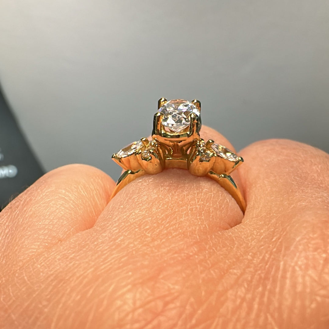 1 CT oval moissanite engagement ring in 14K gold with small moissanite accents.