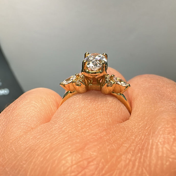 1 CT oval moissanite engagement ring in 14K gold with small moissanite accents.