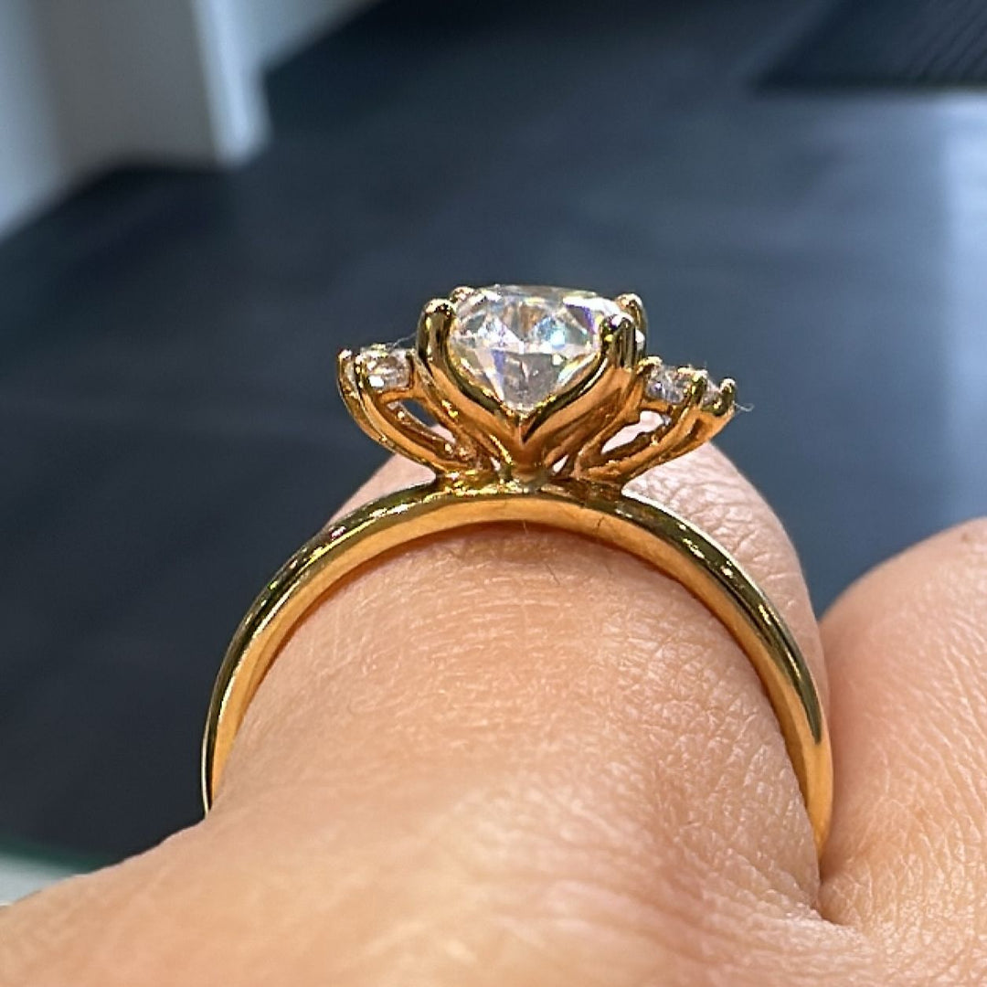 1.20 CT oval moissanite engagement ring with side stones on a 14K gold band.