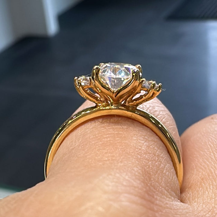 1.20 CT oval moissanite engagement ring with side stones on a 14K gold band.