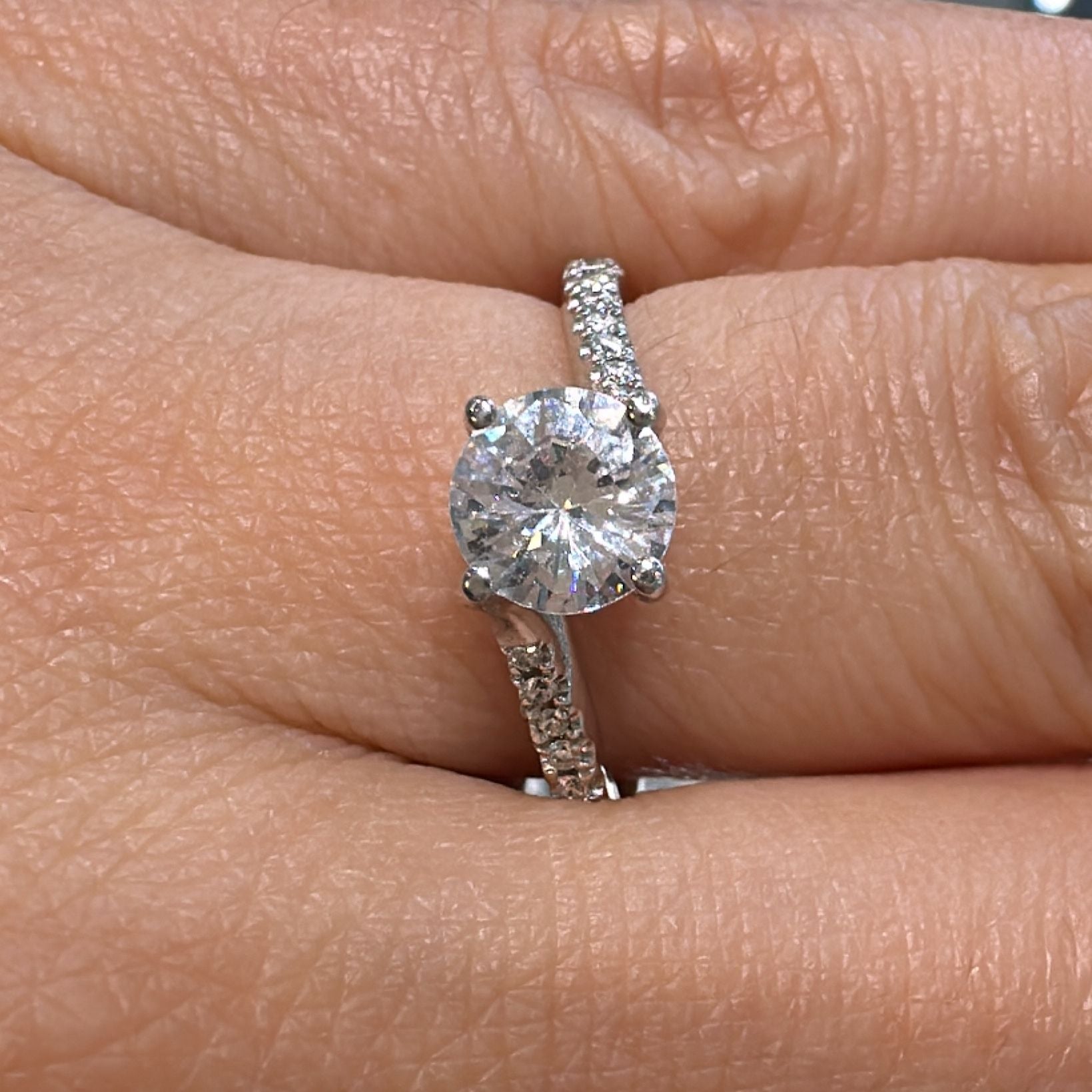 0.80 CT round moissanite engagement ring with diamonds in 14K gold.