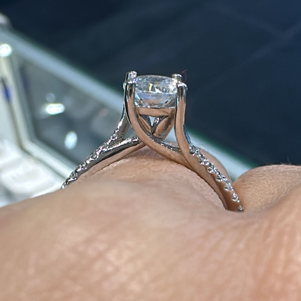 0.80 CT round moissanite engagement ring with diamonds in 14K gold.