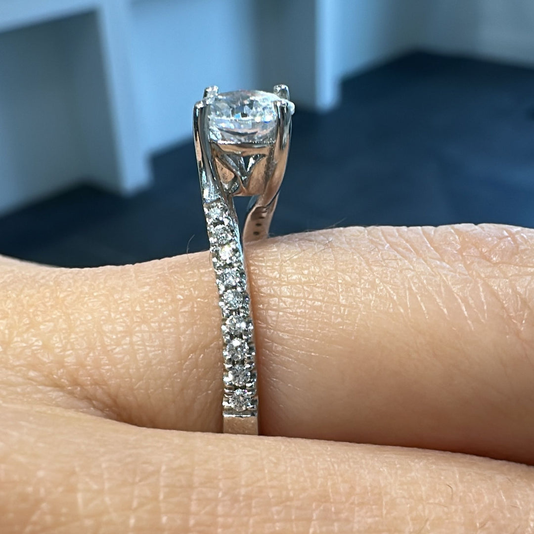 0.80 CT round moissanite engagement ring with diamonds in 14K gold.