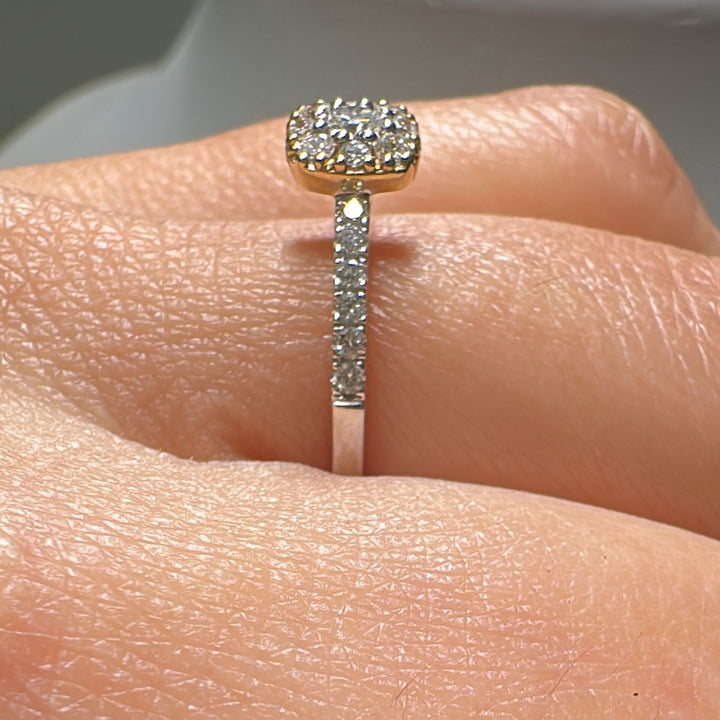 Diamond anniversary ring with halo setting in 14K gold.