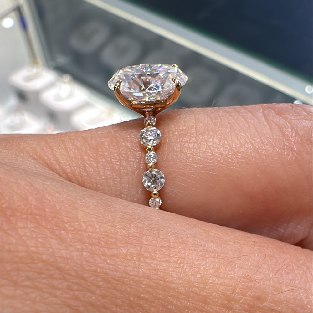 2 CT oval moissanite engagement ring with accent stones in 14K gold.