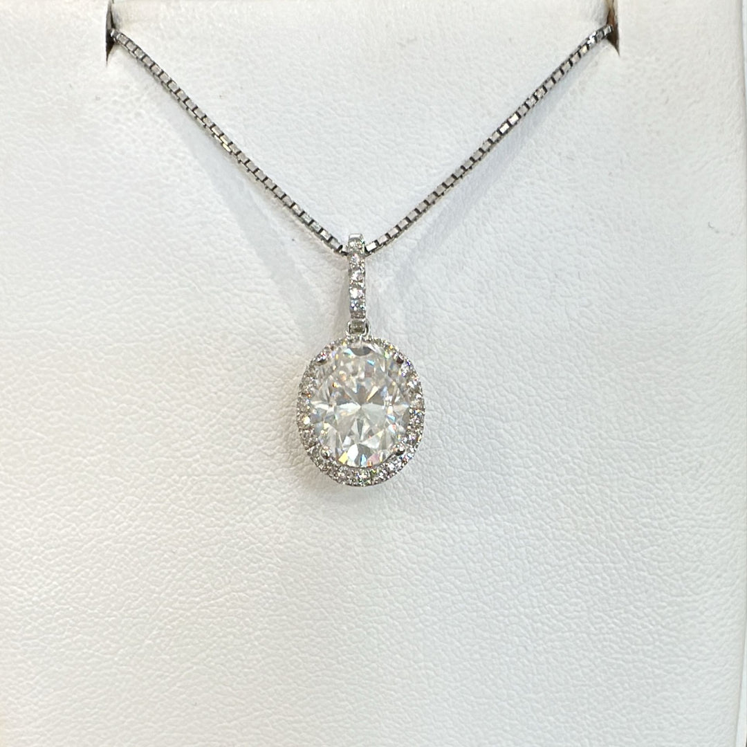 2.5 CT oval moissanite pendant with halo and diamonds in 14K gold.