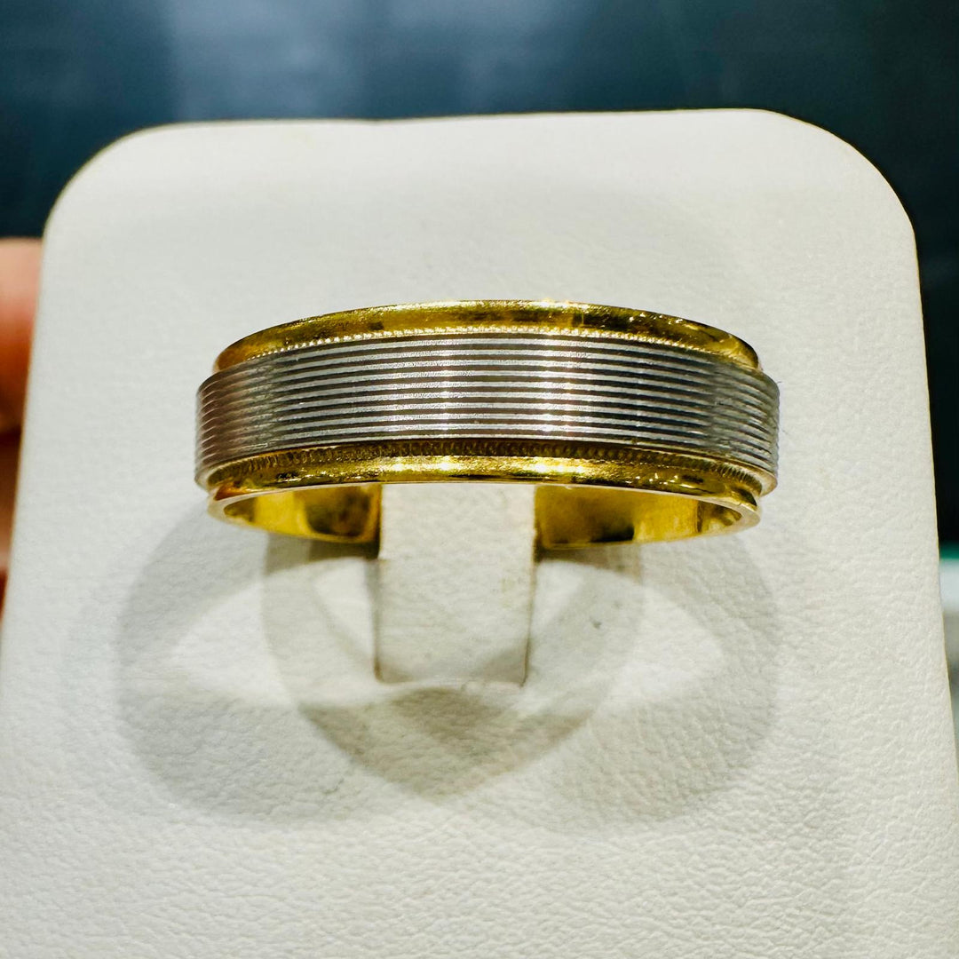 Two-tone men's wedding band with white gold ridged center and yellow gold edges