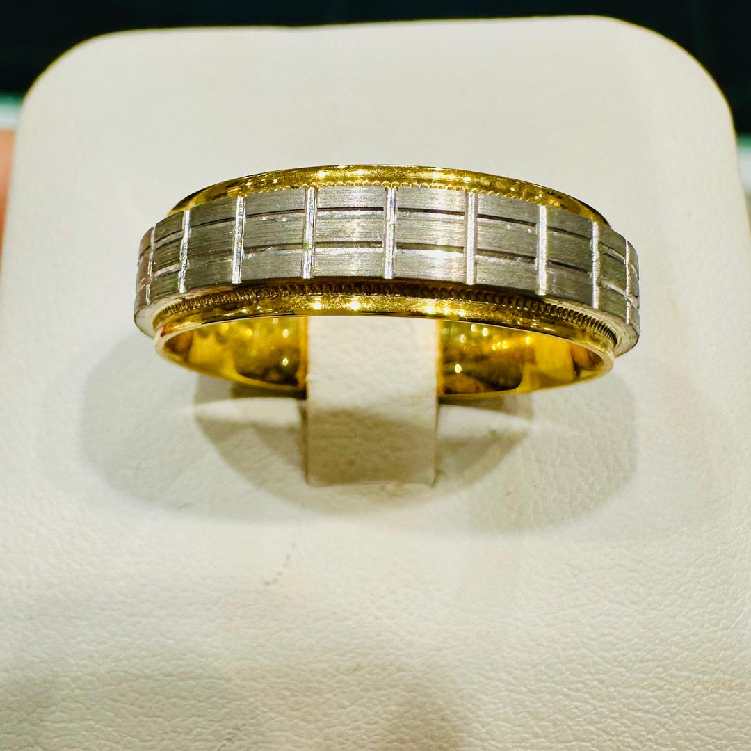 Two-tone men's wedding ring with grid-patterned white gold center and yellow gold edges