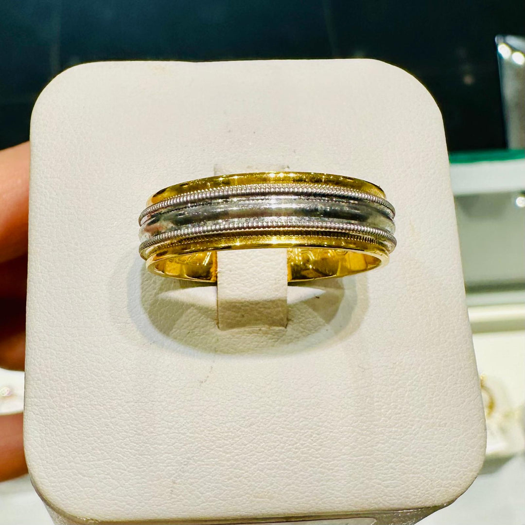 Two-tone men’s wedding band with polished white gold center and milgrain accents