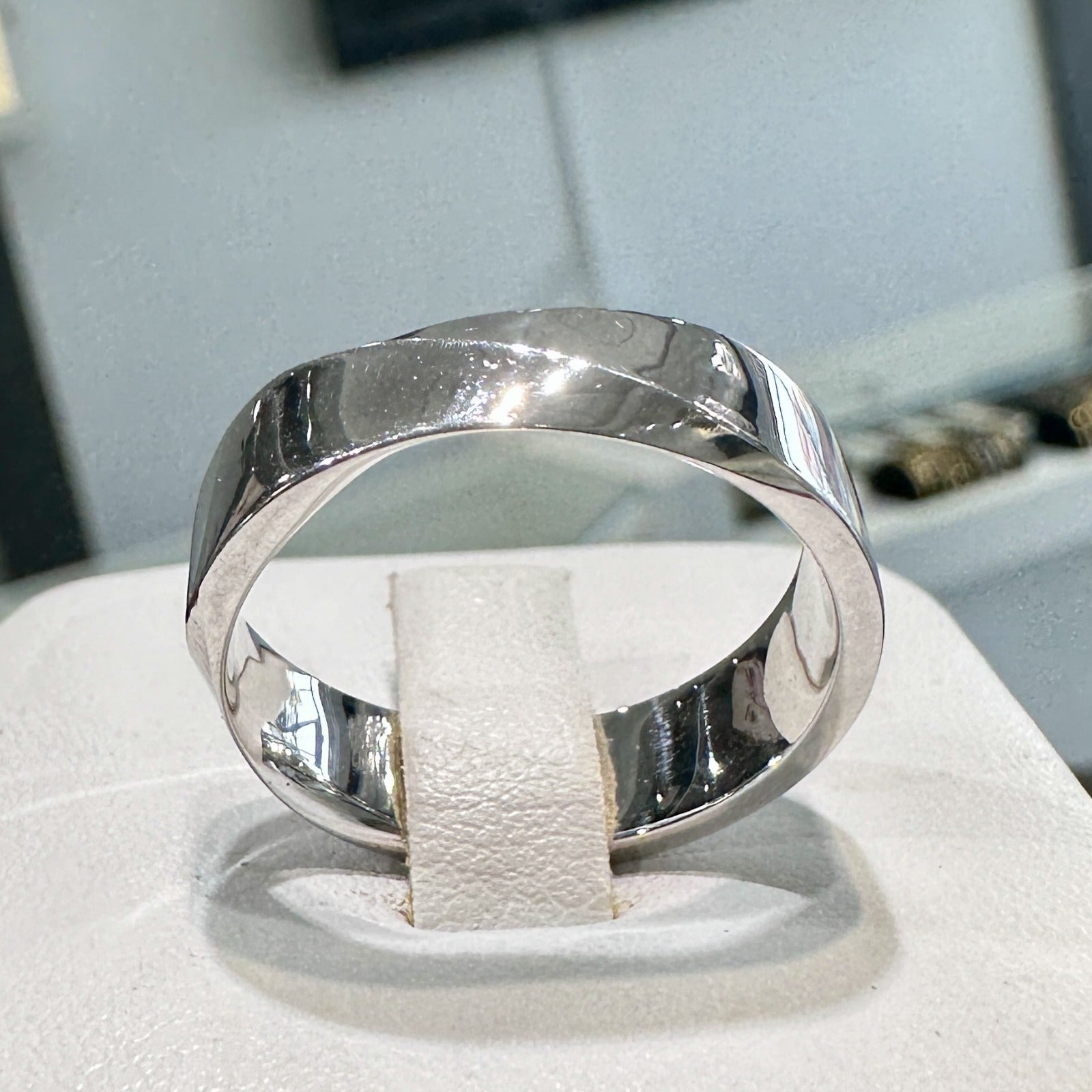 6mm 10K white gold men's wedding band with high-polish finish on display