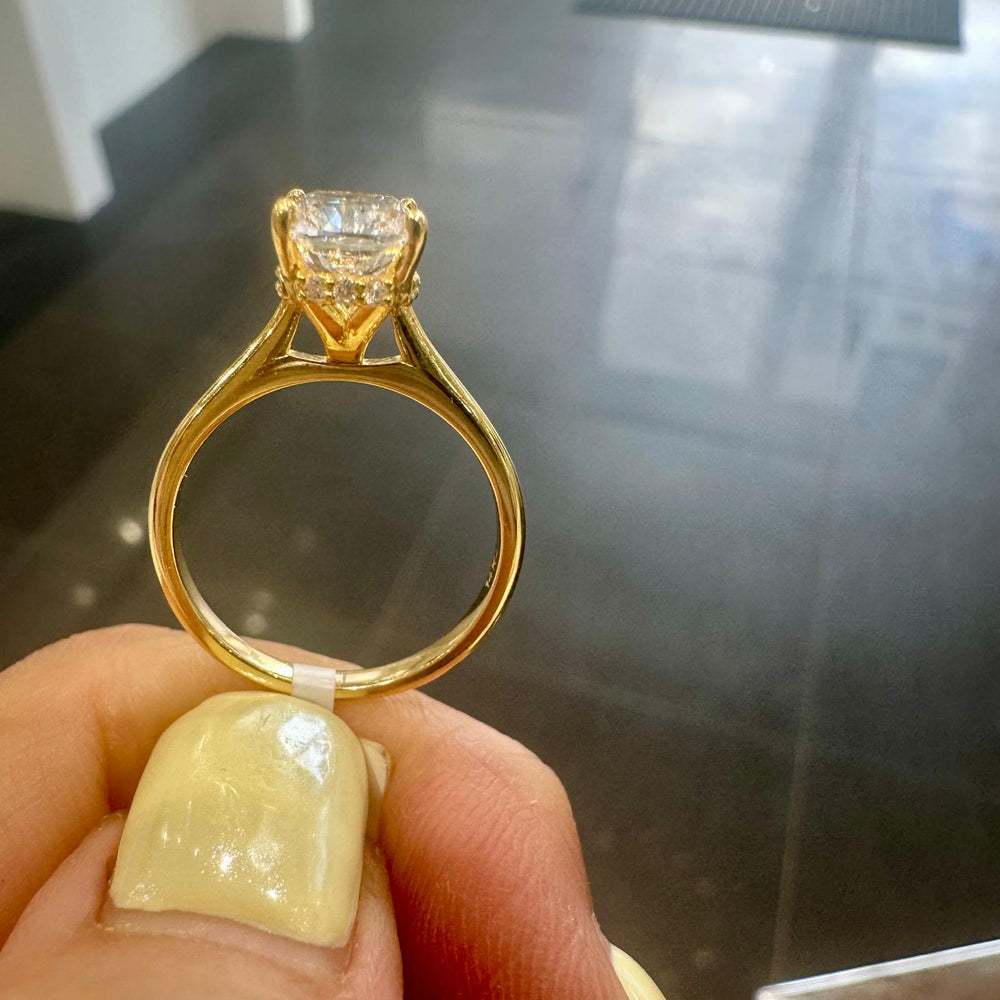 Radiant cut diamond engagement ring in yellow gold with hidden halo setting