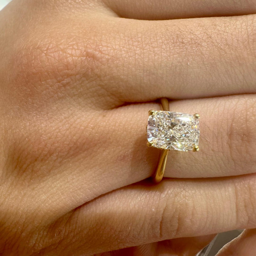 Radiant cut diamond engagement ring in yellow gold with hidden halo setting