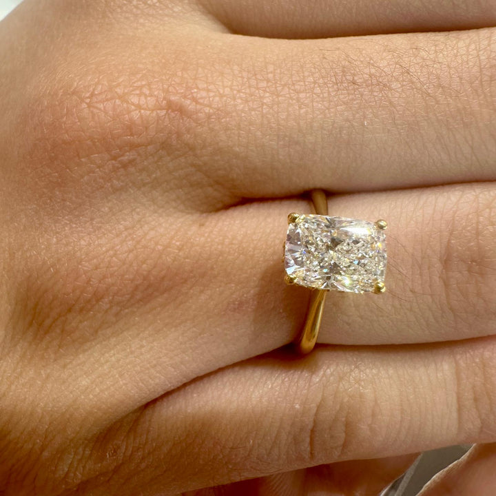 Radiant cut diamond engagement ring in yellow gold with hidden halo setting