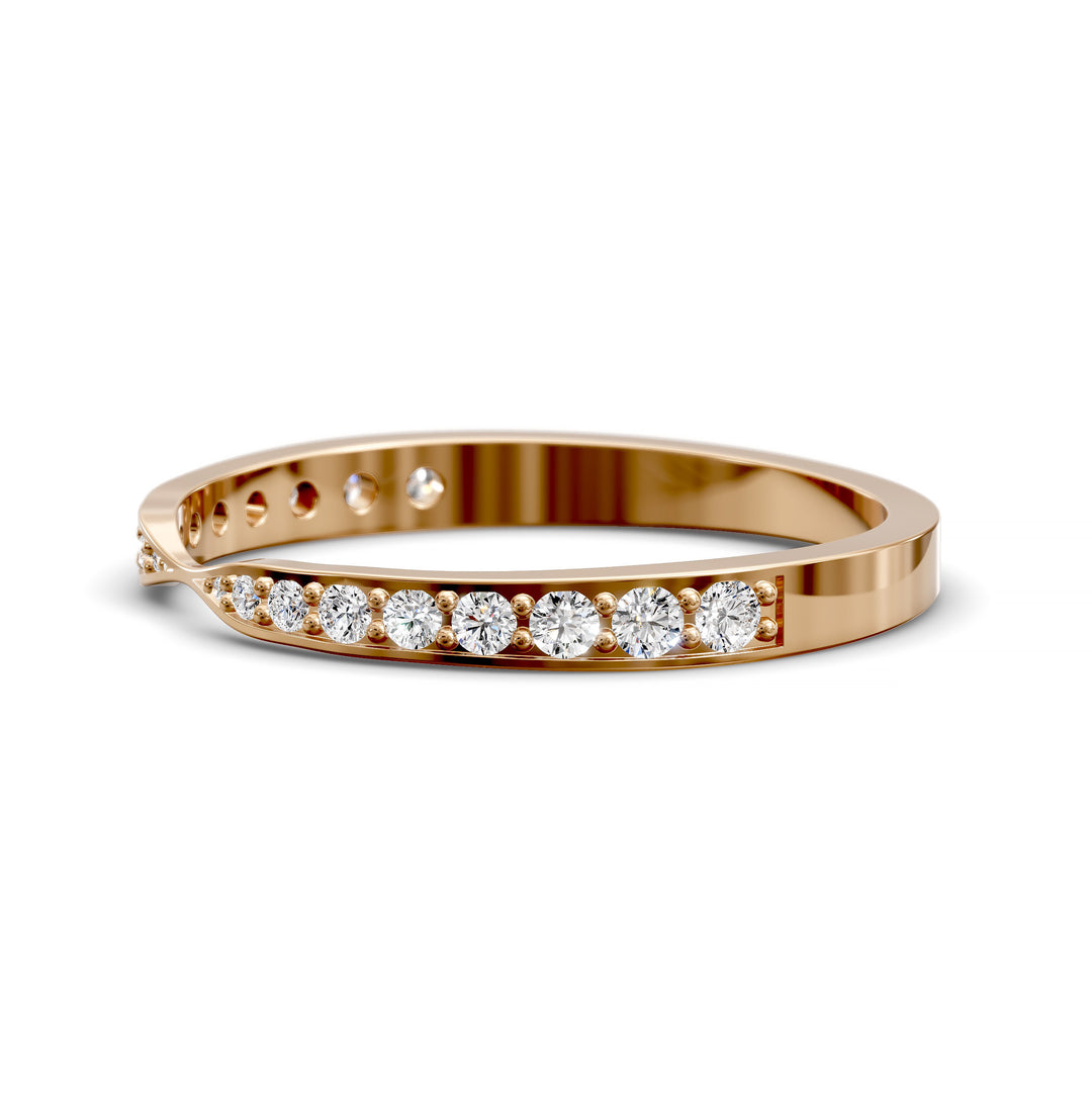 Channel set gold wedding band with tapered top and round brilliant stones