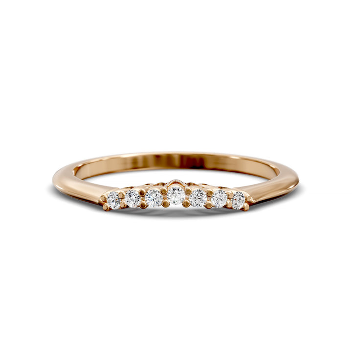 Curved diamond wedding band with shared-prong setting and open gallery, featuring seven round stones