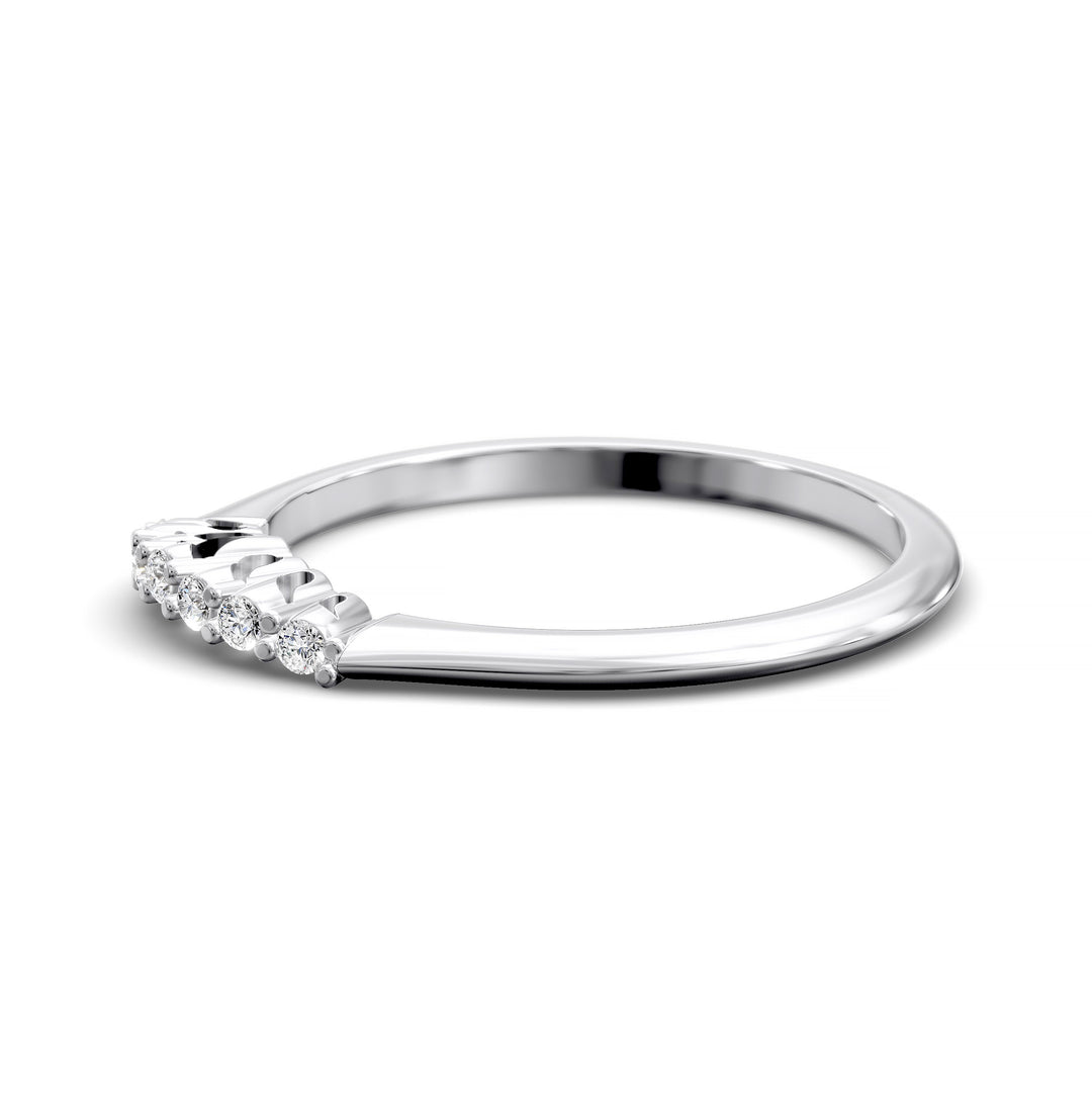 Curved diamond wedding band with shared-prong setting and open gallery, featuring seven round stones