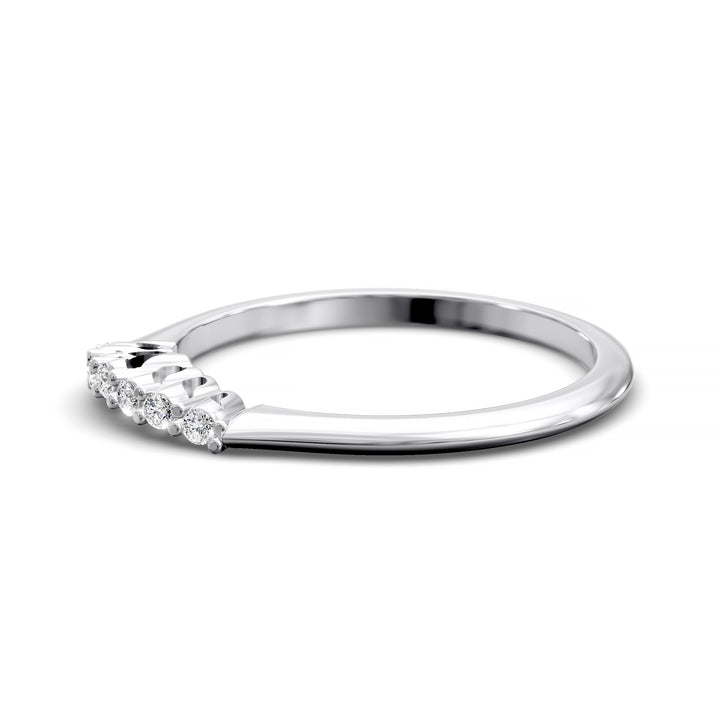 Curved diamond wedding band with shared-prong setting and open gallery, featuring seven round stones