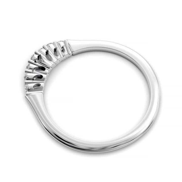 Curved diamond wedding band with shared-prong setting and open gallery, featuring seven round stones