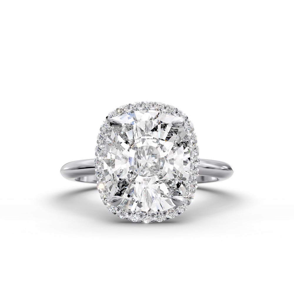 Elongated cushion halo diamond engagement ring with sleek band in studio lighting.