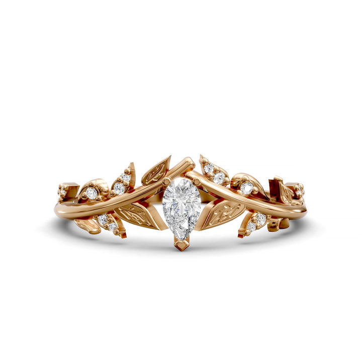 Leaf and vine wedding band with pear-shaped center stone and small accent stones