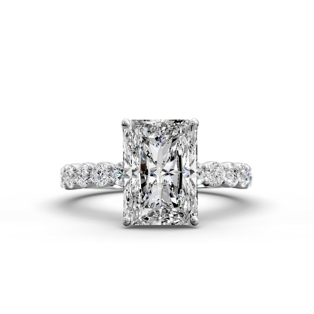Radiant cut hidden halo engagement ring with seamless prong setting and pave band