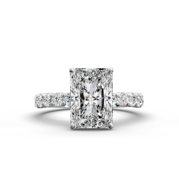 Radiant cut hidden halo engagement ring with seamless prong setting and pave band